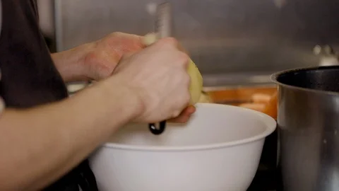 Peeling potatoes in a restaurant kitchen Stock-Footage 117993796