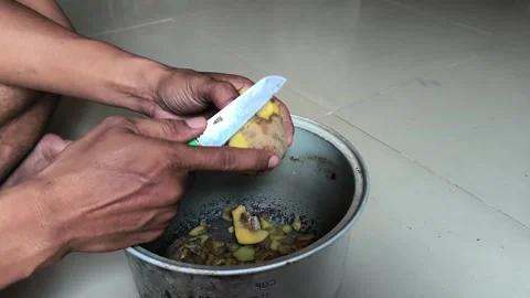 Peeling potatoes using a knife Stock Footage 329492568
