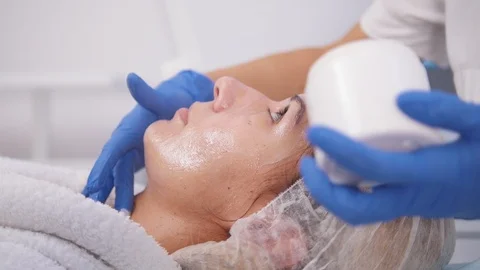 Peeling procedure. Smearing cream on the face. Close up Stock Footage 98094136