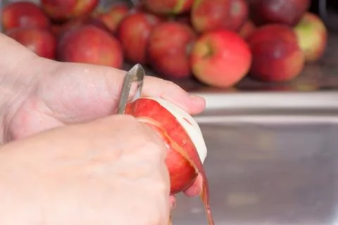 Peeling a red apple Stock Photos