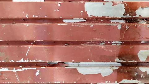 Peeling red paint. dirty profiled metal sheet. Stock Photos