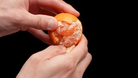 Peeling a satsuma mandarin Stock Footage 320923257