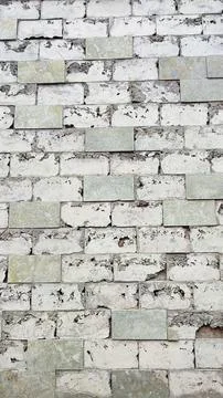 The peeling square stone wall on the side of the road is perfect for the backgro 스톡 사진