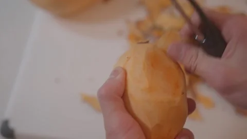 Peeling Sweet Potato from high angle - Making Sweet Potato Risotto - Clip 3 Stock Footage 243082344