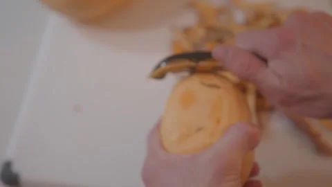 Peeling Sweet Potato from high angle (ALT)- Making Sweet Potato Risotto - Clip 4 Stock Footage 243082345