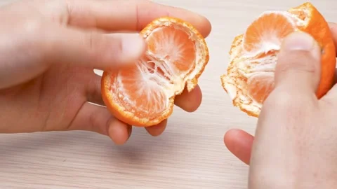 Peeling tangerines on table, 4K video, with sound. Stock Footage 288787111