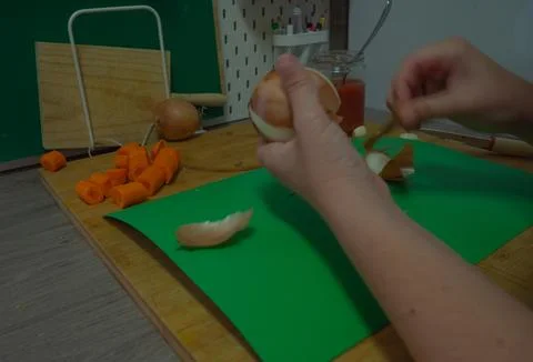 Peeling vegetables in the kitchen Stock Photos