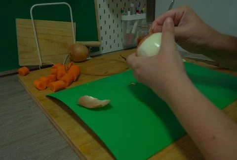 Peeling vegetables in the kitchen Stock Photos