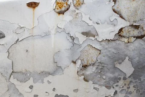 Peeling white paint and rust stains on a abandoned car, close up abstract t.. Stock Photos