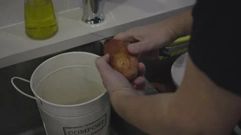 Peeling yam at the kitchen sink. Stock-Footage 146238403