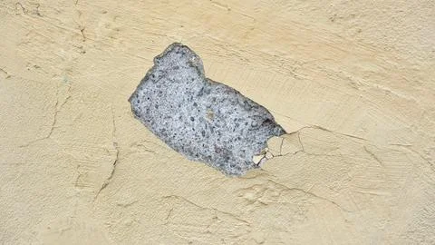 A peeling yellow wall. Stock Photos