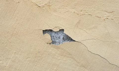 A peeling yellow wall. Stock Photos