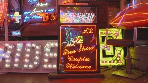 Peep show live couples welcome neon sign Stock Footage 100475057