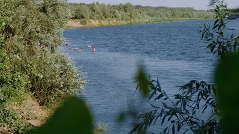 Peeping at people bathing in the river Stock Footage 135817128