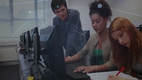 Peer student pointing at screen, guiding pair coding and notes in computer lab Video stock 311962955