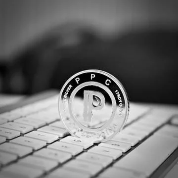 Peercoin on the white keyboard Stock Photos