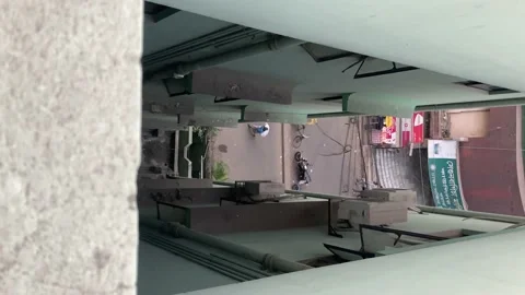 Peering Over To See In Between Narrow Apartments Down To Street With Vídeo Stock 170283791