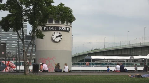 Pegel clock building Koln bridge Rhine river cloudy day pedestrian people walk  Stock Footage 40544456