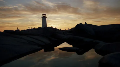 Peggys Cove lighthouse at sunset - reflection in water Stock Footage 202619056