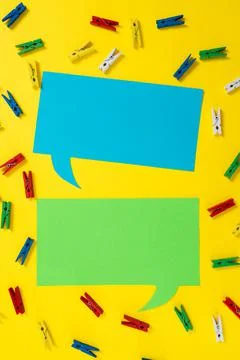 Pegs Placed Around Two Speech Bubbles With Important Information. Wooden Clips Stock Photos