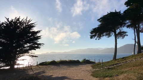 Pelicans flying over Baker Beach at sunset in San Francisco Stock Footage 114220608