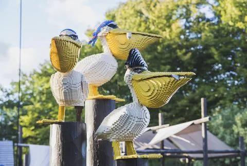 Pelicans made of constructor sit on stumps Legoland Stock Photos
