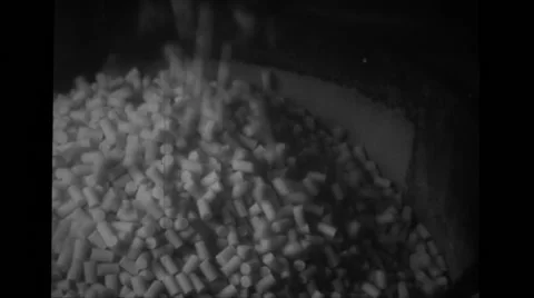 Pellets coming out of machine in manufacturing plant Stock Footage 37593900