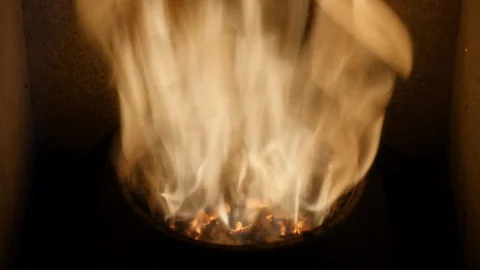 Pellets in flames- oak biomass, close up : Heathing - renewable energy from Stock Footage 128139156
