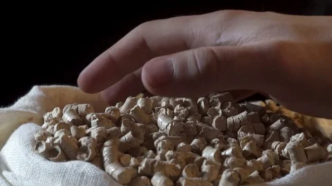 Pellets run out of hand on black ground Video stock 83118543