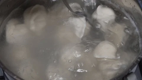 Pelmeni (meat dumplings) being boiled in pan. 20x fast Stock Footage 100670082