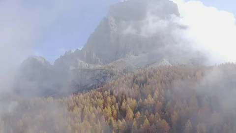The Pelmo mountain and an orange forest in the middle of clouds, Dolomites Stock-Footage 129823323