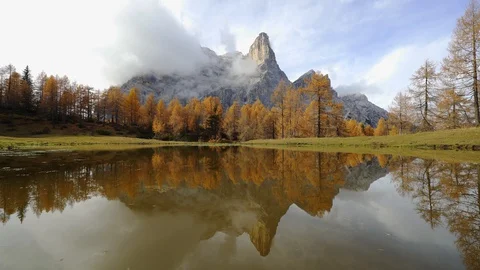 Pelmo Mountain reflected on a small Lake, Autumn Stock Footage 129814199