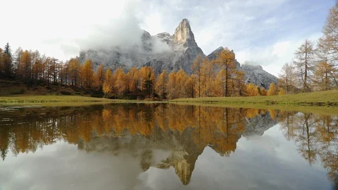 Pelmo Mountain reflected on a small Lake, Autumn Stock Footage 129815697