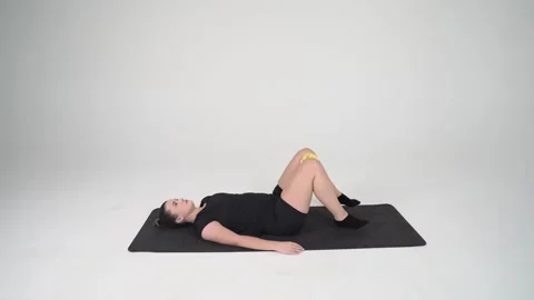 Pelvic Tilts squeeze lifting the legs up and pushing back on the knees Stock Footage 314194254