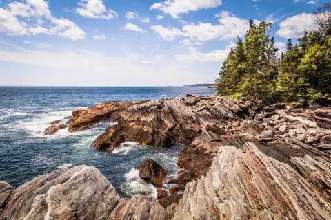 Pemaquid Point Lighthouse atop dramatic rocky coast in Bristol, Maine Stock Photos