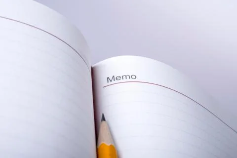 Pen above notebook Stock Photos