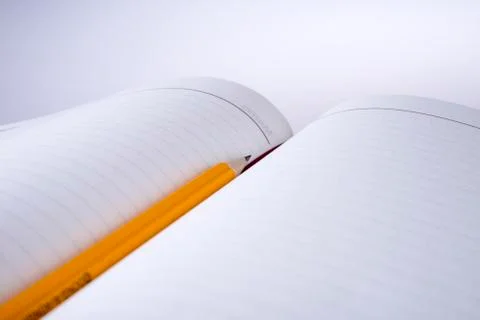 Pen above notebook Stock Photos