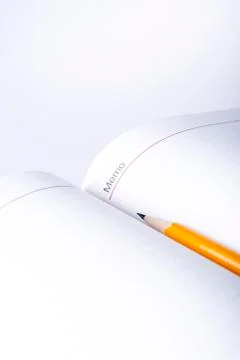 Pen above notebook Stock Photos
