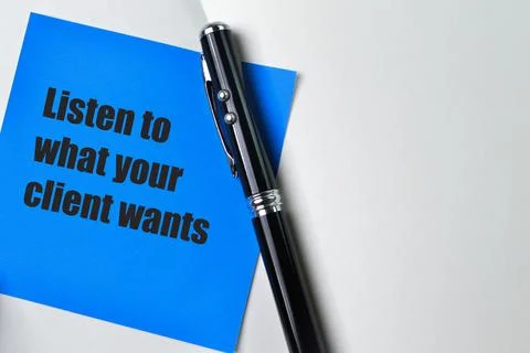 Pen and blue note phrase LISTEN TO WHAT YOUR CLIENT WANTS Stock Photos