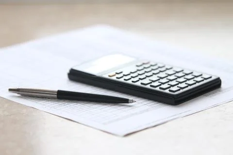 Pen and calculator Stock Photos