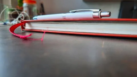 Pen and diary side view on workspace with selective focus Stock Photos