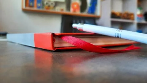 Pen and diary side view on workspace with selective focus 스톡 사진