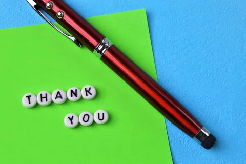 Pen and green note with text THANK YOU Stock Photos
