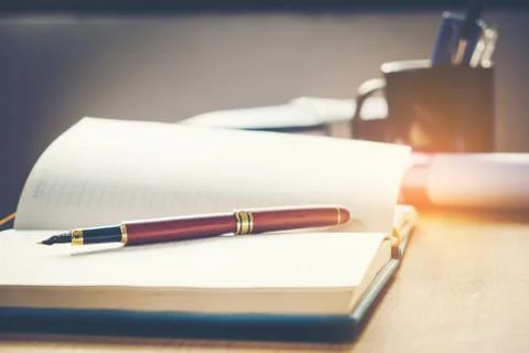 Pen and notebook on the table Stock Photos