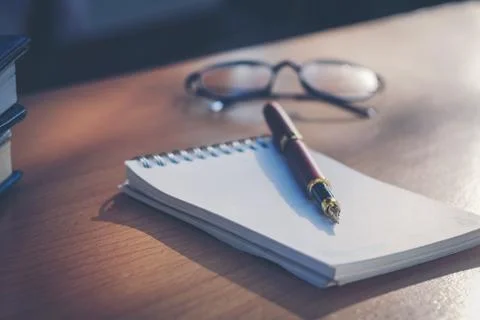 Pen and notebook on the table Stock Photos