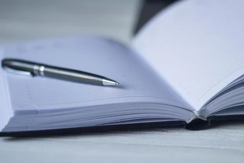 Pen and a notebook at the workplace Stock Photos