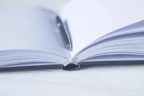 Pen and a notebook at the workplace Stock Photos