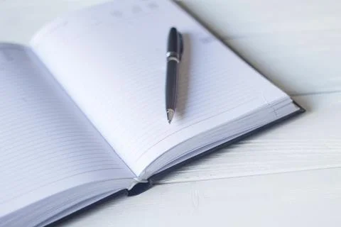 Pen and a notebook at the workplace Stock Photos