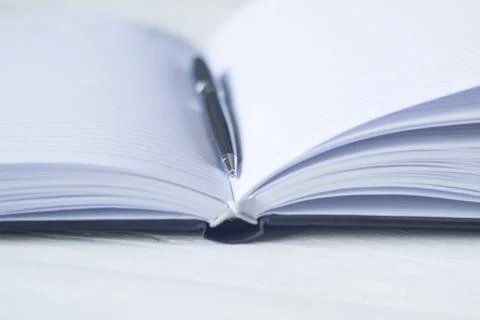 Pen and a notebook at the workplace Stock Photos