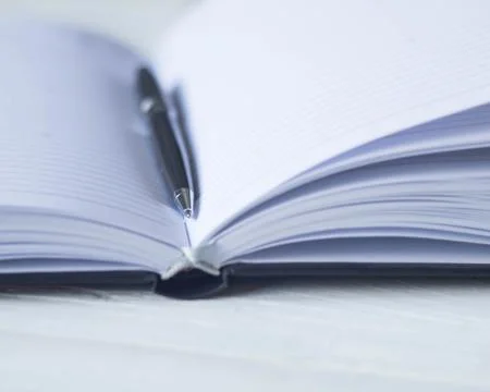Pen and a notebook at the workplace Stock Photos